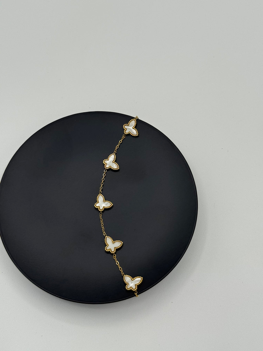 Golden color metal bracelet with white butterflies