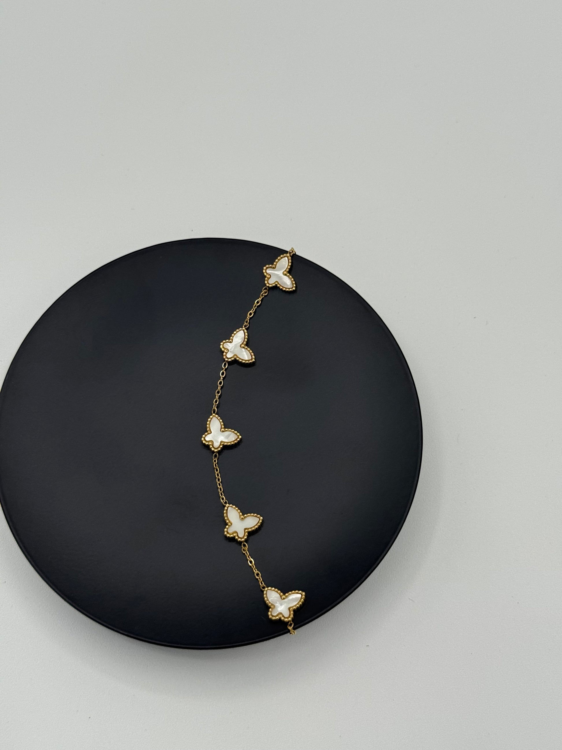 Golden color metal bracelet with white butterflies