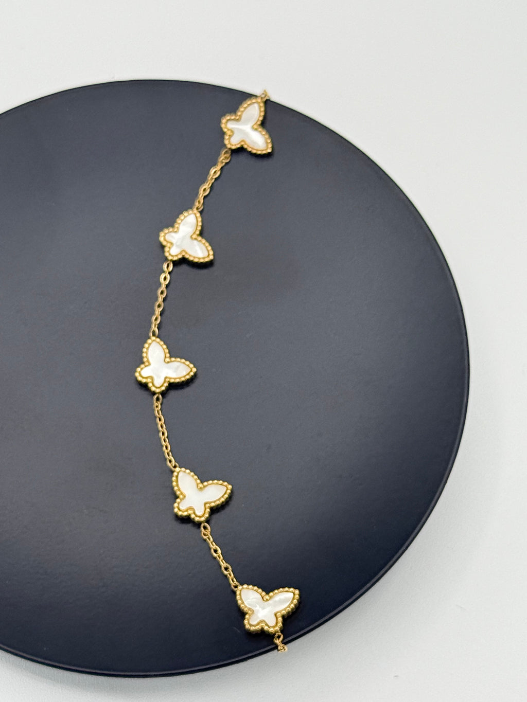 Golden color metal bracelet with white butterflies