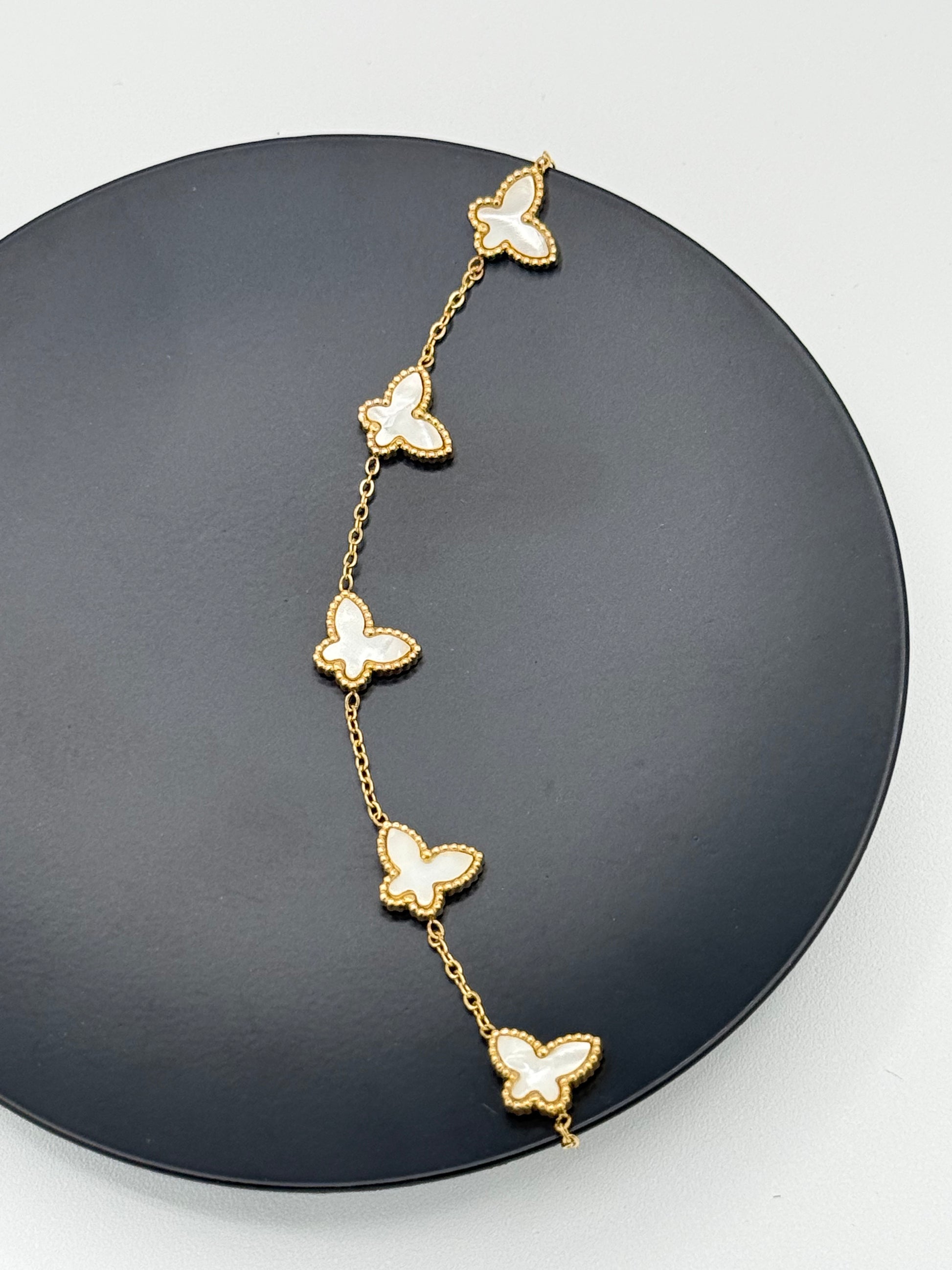 Golden color metal bracelet with white butterflies